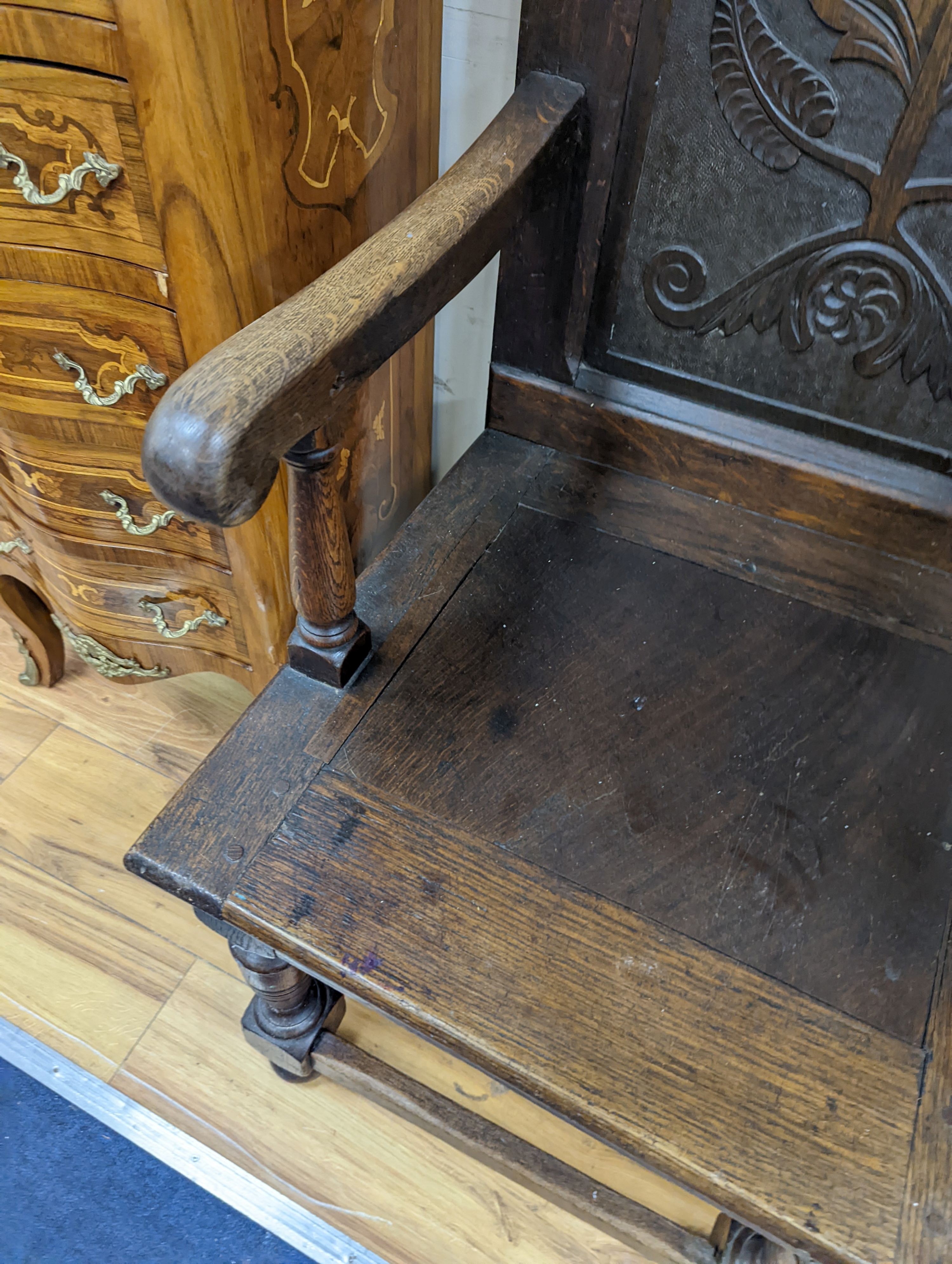 A 17th century style oak wainscot chair, width 54cm, height 122cm